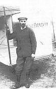 Farman by the tail of his aircraft